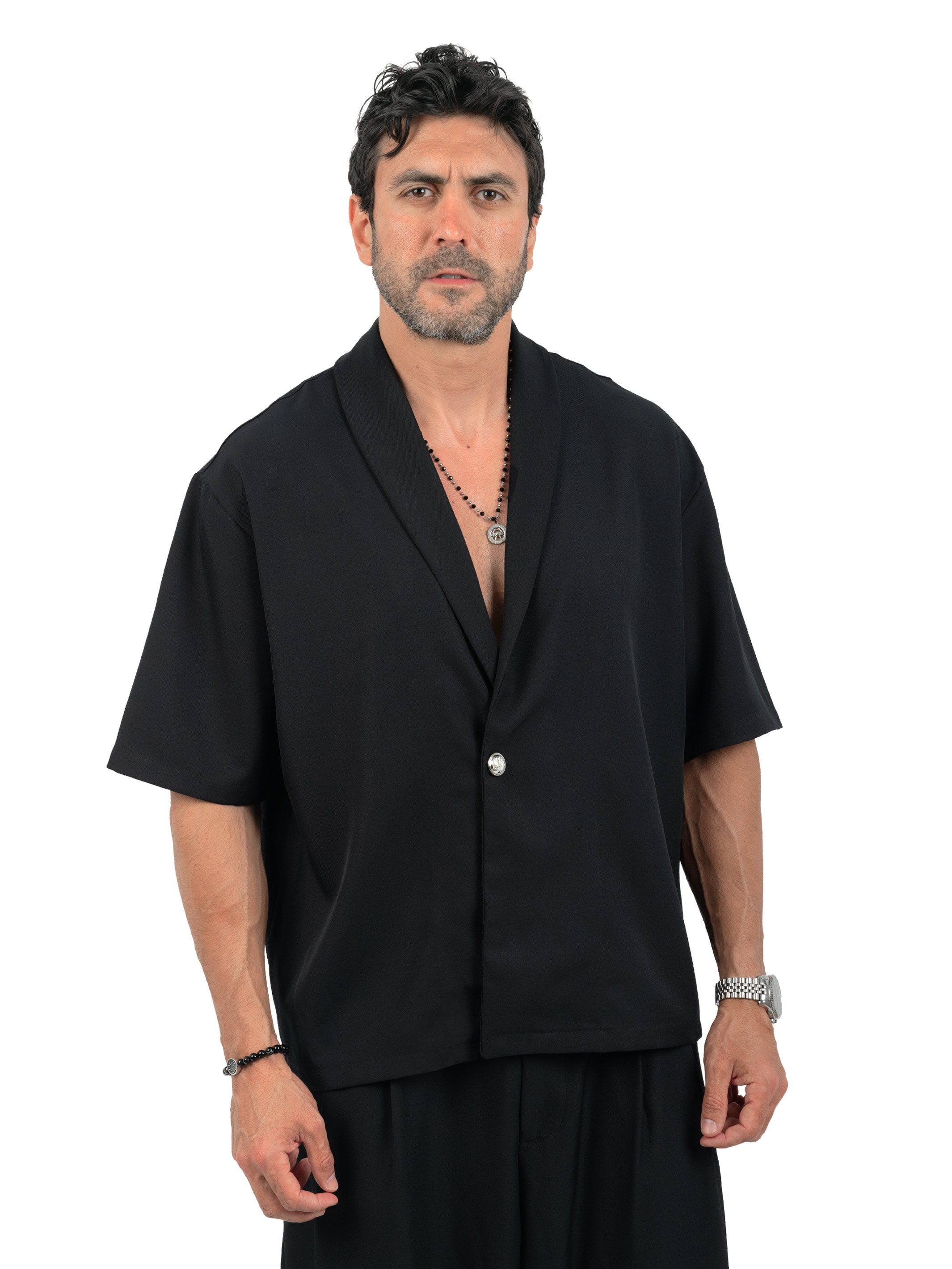 Man wearing a black short-sleeve shirt on a white background