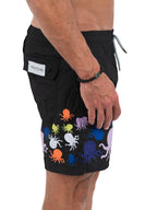 Black shorts with colorful octopus pattern worn by a person on a white background